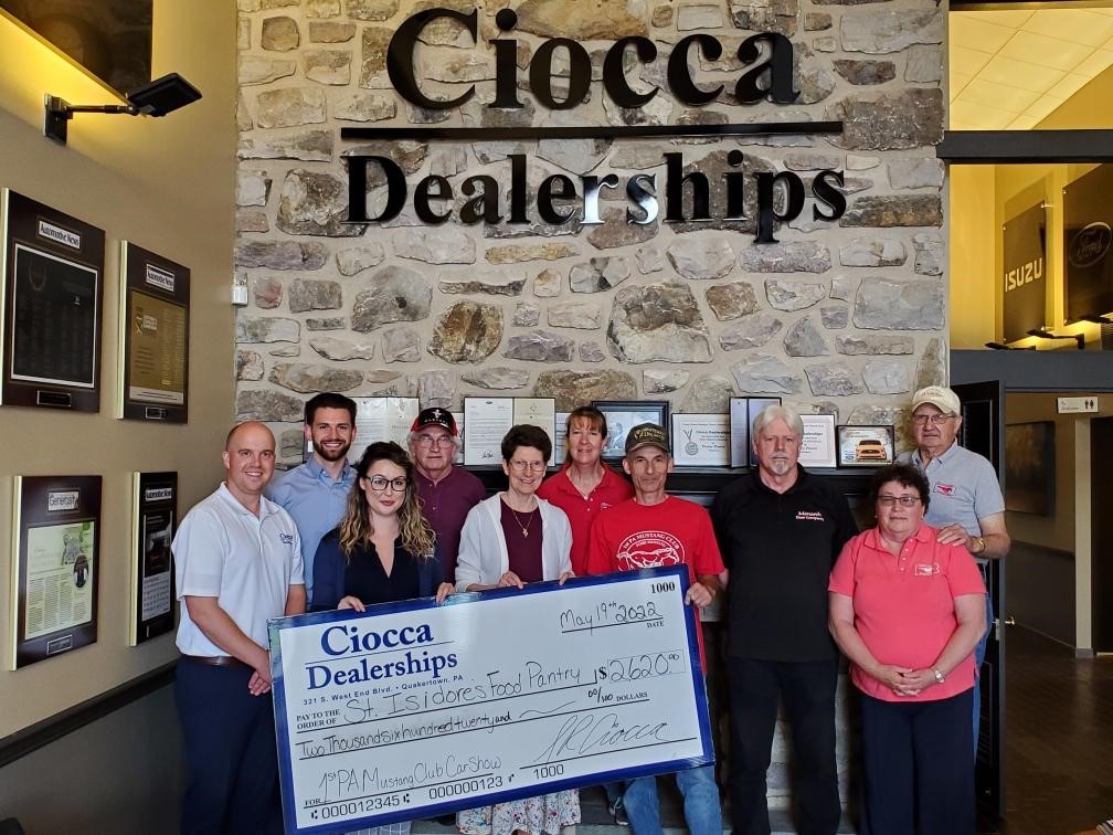 A check presentation by members of the First Pennsylvania Mustang Club